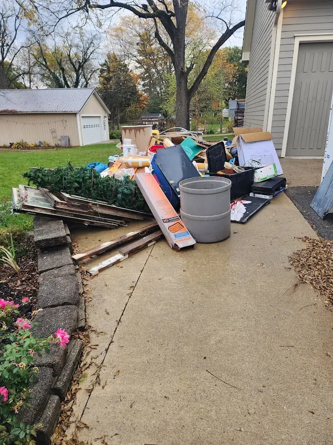 Dumpster being loaded with debris for Roofing Dumpster Rental in Inverness